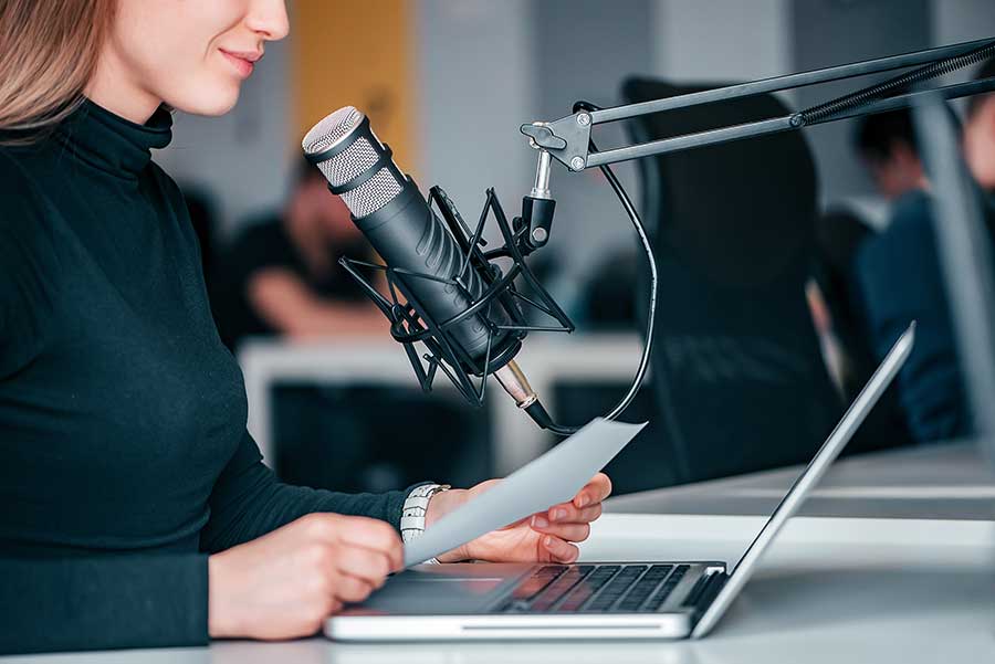 Woman recording voice over on microphone