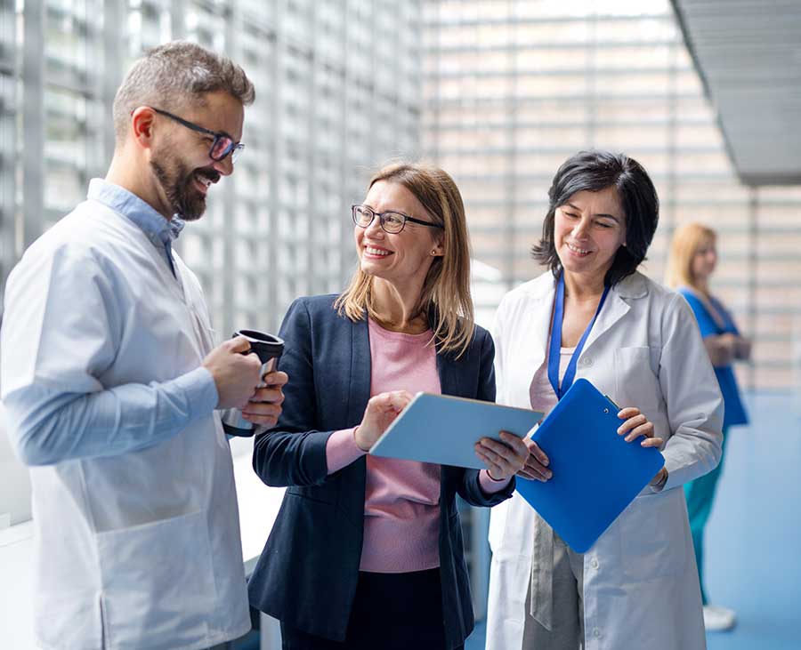 Medical staff discussing items on a chart board