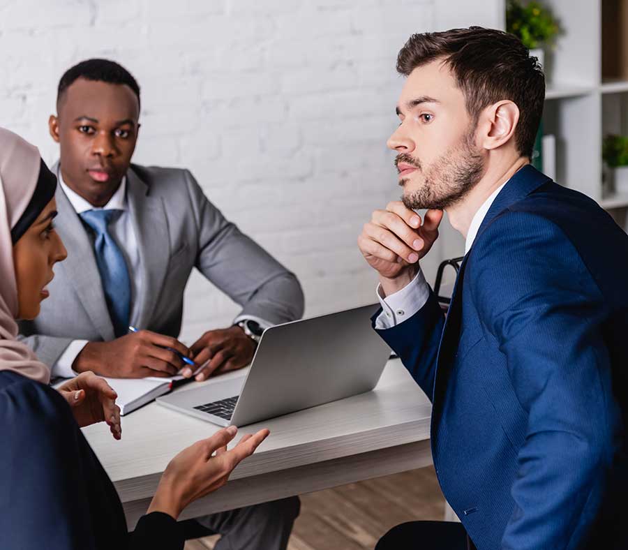 Arab lady, African male and white man in office meeting