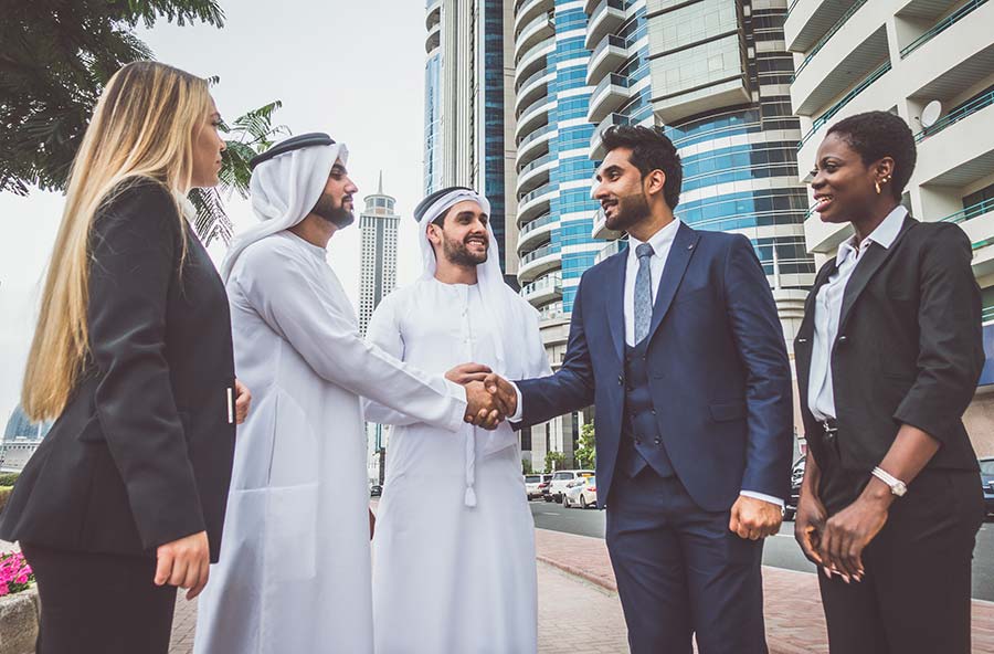 Arabic people handshake with people in suits