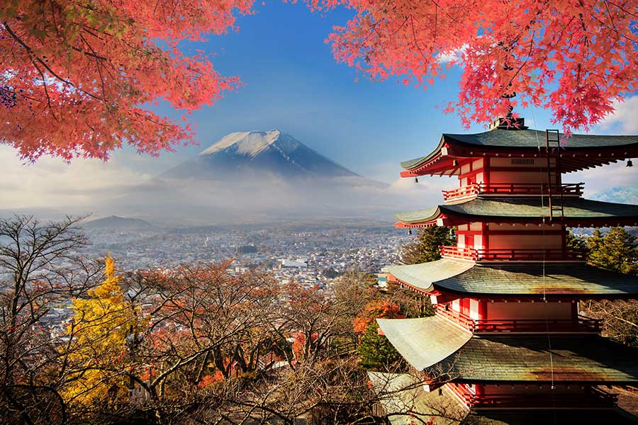 A serene Japanese pagoda stands against the majestic backdrop of Mount Fuji. 