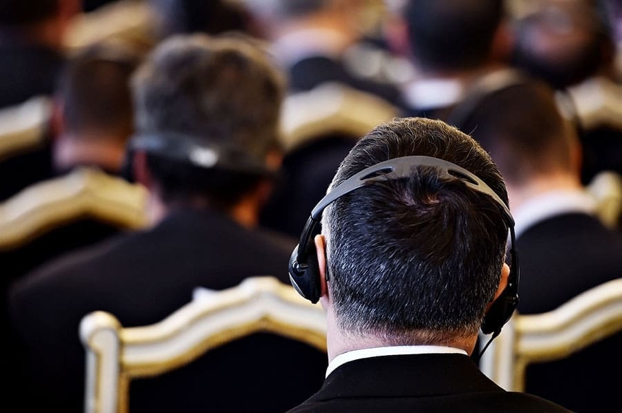 Man with headphones listening to simultaneous (Conference) Interpreting
