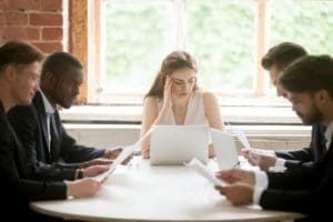 A group of people sitting at a table Description generated with very high confidence