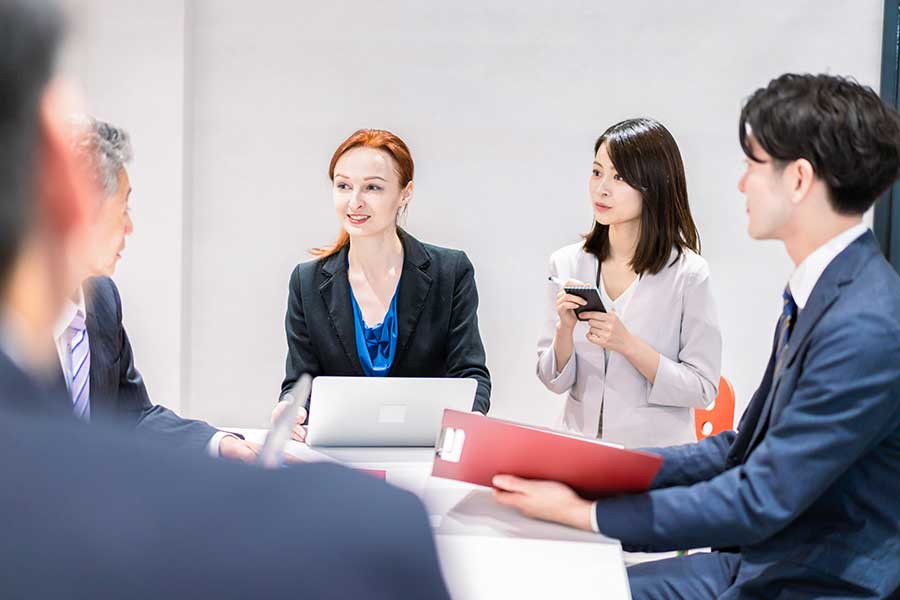 Meeting of ethnically diverse people in a business setting. 